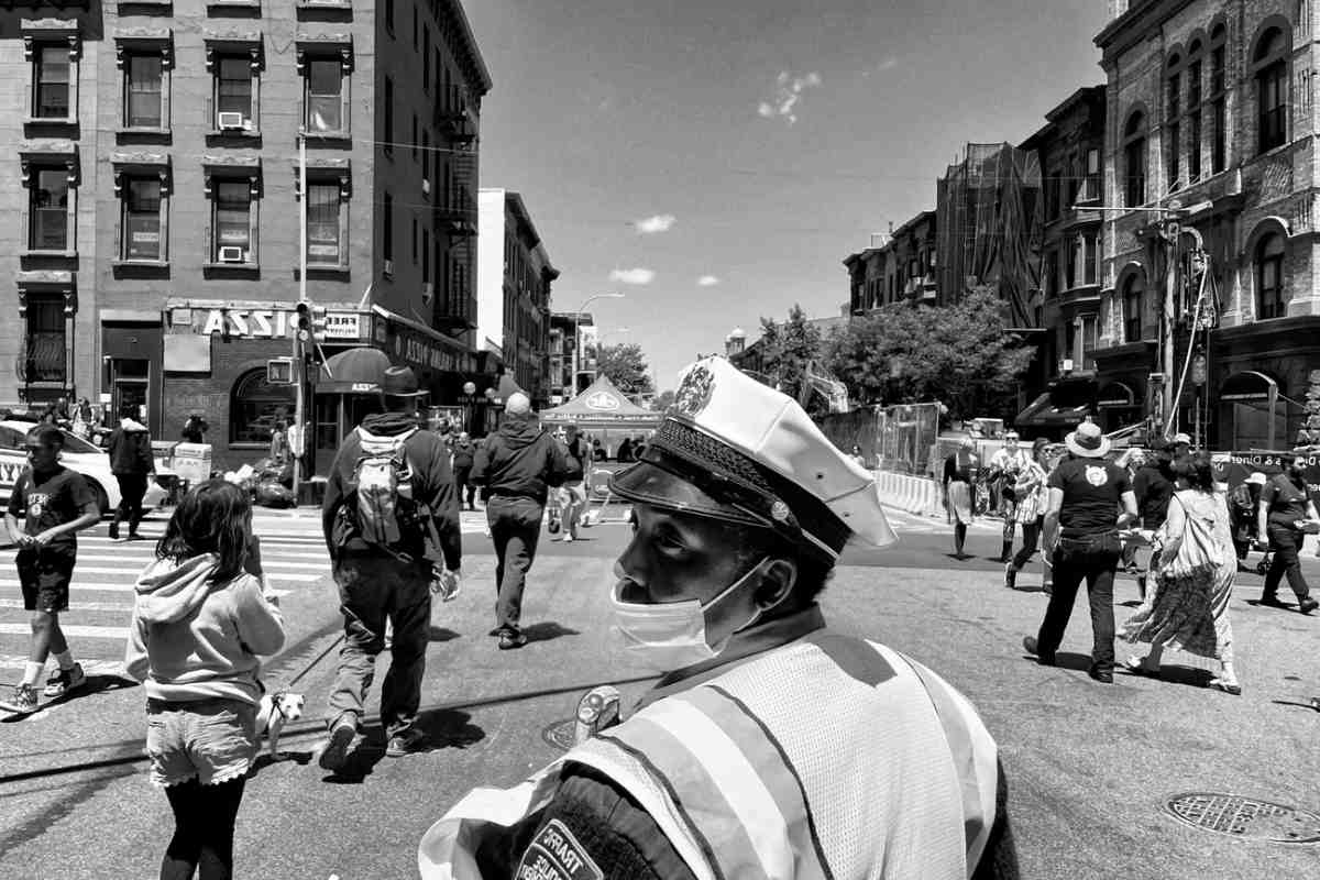A traffic officer directs pedestrians during a fair in Brooklyn, New York